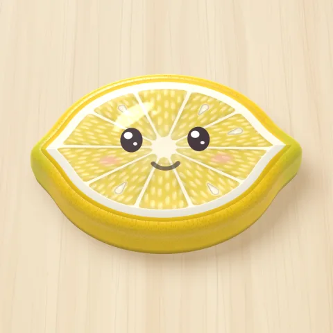 A jelly lemon with a smiling face on a wooden board