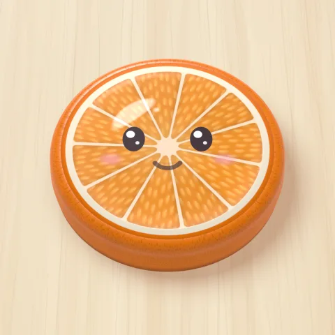 A jelly orange with a smiling face on a wooden board